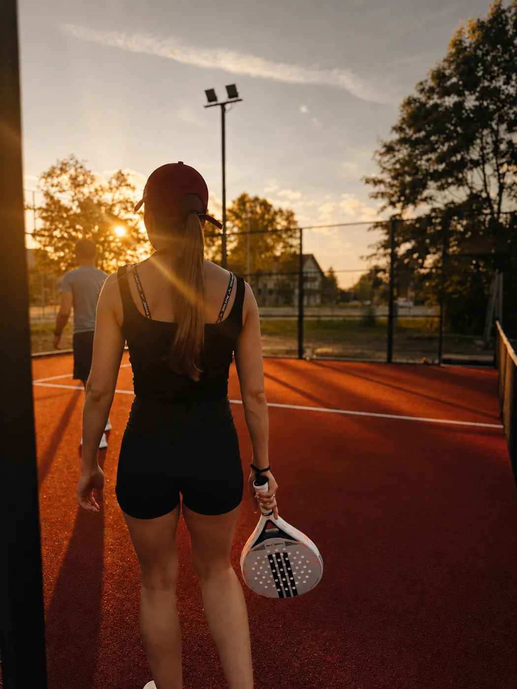Padel player at sunset in central Sigulda
